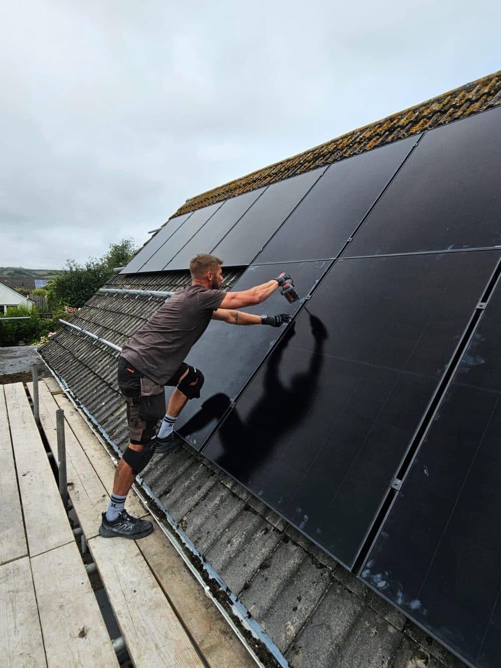 Jamie installing solar panels on a Cornwall roof